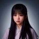 问鼎app技术架构师李思雨——扎马尾的女性技术专家，专注地看着笔记本屏幕，背景为蓝色代码界面，技术氛围浓厚